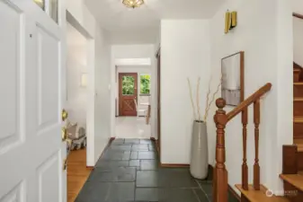 Entry foyer with cool mid-century slate leads you into bright interiors that flow in a sought-after circular layout.
