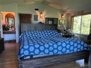 This large primary bedroom allows for central bed placement, built in vanity, lots of windows and 5 piece primary bath and walk-in closet to the left in this photo.