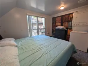 Bedroom with private deck, closet and combo washer/dryer. Very comfortable space.