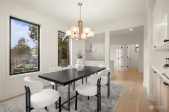 Formal dining space overflowing with natural light and beautiful custom built-in cabinetry.