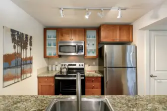 Galley kitchen features plenty of counter and cupboard space.