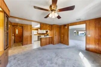 Dining room w/ kitchen in background, liv room to the right & laundry room & back door in the background