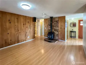 Secondary Living Room with wood burning stove and river rock accent wall