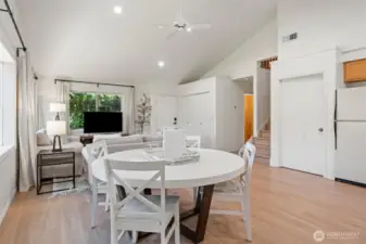 Open floor plan blends kitchen, dining, and living areas in a harmonious layout—accented by airy neutral decor and luxe furnishings