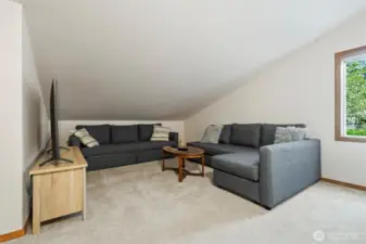 Generously sized loft suite with a comfortable seating area and full bathroom, offering flexibility as a guest suite, home office, or personal sanctuary