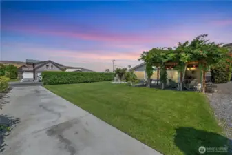 Large, landscaped yard with an RV parking pad and room for toys — ideal for guests, families, or as flexible rental space