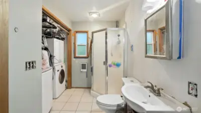 This 3/4 bath is also home to the washer and dryer with additional storage space.