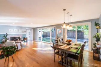 Living room includes a cozy, natural wood-burning fireplace updated with intricate tile surround.