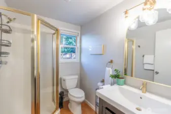New mirror, lighting and vanity in this lovely 3/4 bathroom.