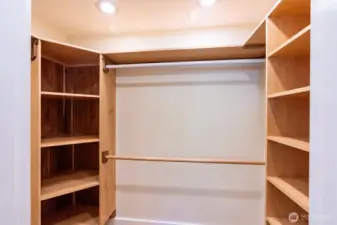 Walk-in closet with custom shelving.