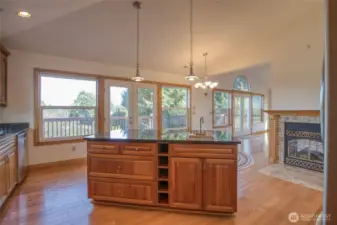 Kitchen Island with a wall of bright windows and doors