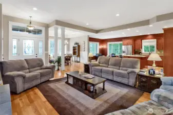 Large windows bring in natural light and views of the surrounding greenery.