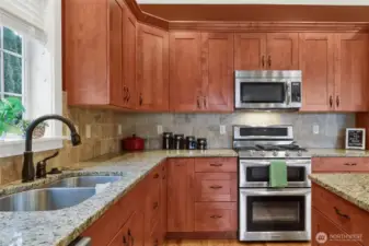 Stainless appliances and detailed finishes complete this inviting kitchen