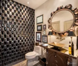 The wall of raised glass tiles shimmer and the custom gold vanity with smoked mirror is jaw dropping gorgeous.