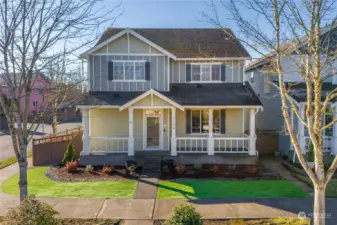 Corner lot with covered front porch and easy to maintain landscaping