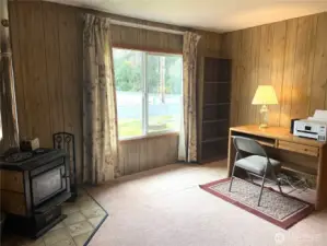 Large window viewing the fenced front yard. Wood Stove for our cool nights and plenty of firewood next to the garage comes with the house.