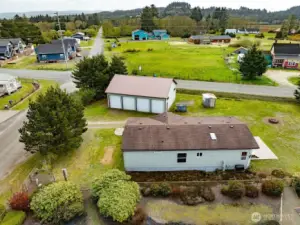 Mixed-Use Zoned 3-bedroom home and shop with a fully fenced .31 acre yard has a 1200 square foot 4 bay shop with a 100 amp service for all your toys or projects, plus an RV hookup