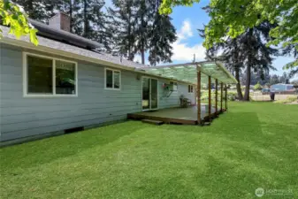 View of covered deck and view of neighboring pasture. He boards 2 horses. They like to visit for apples.