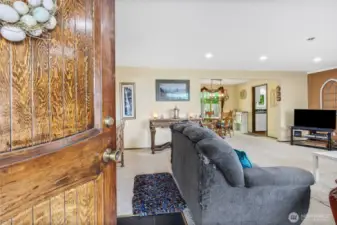 Entering Front door into spacious family room, open concept.