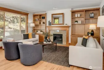 The kitchen opens to the inviting family room, complete with built-in cabinetry and a cozy gas fireplace—creating the perfect setting for gatherings, relaxing evenings, and everyday living.