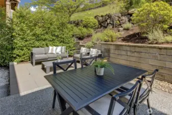 Thoughtfully designed with low-maintenance pavers, it’s the perfect spot to relax, entertain, or showcase your favorite potted plants in a sun-dappled garden setting.