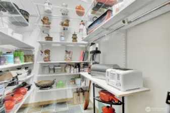 Walk in pantry with custom shelving.
