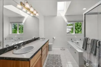 5 pc Primary Bathroom Suite with Jetted Soaking Tub, Glass Surround Shower, and His & Her Sinks along with a Walk In Closet