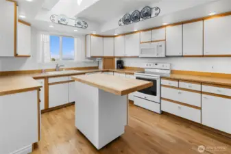 TONS of storage in kitchen, island is butcher block and cabinets are real oak trim!