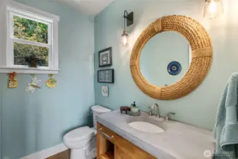 Main floor powder room updated with new vanity, toilet and fixtures