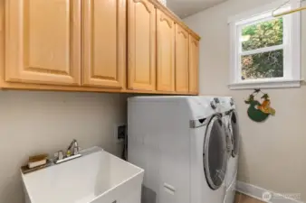 Laundry room with utility sink, lots of cabinet storage