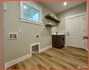 Utility/laundry room with sink/vanity and floating shelves. Tankless water heating system.