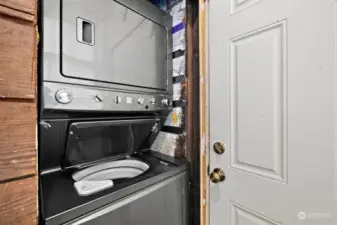 Space saving stackable washer and dryer in back entry mud room area.
