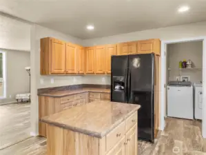 View to the utility/mud room has area for pantry storage and door leading outside to the garden.