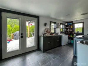 Outdoor access to covered deck and shot of utility and mud room.