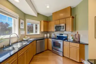 Functional kitchen with stainless steel appliances, electric stove, and ample cabinetry—perfect for the home chef.
