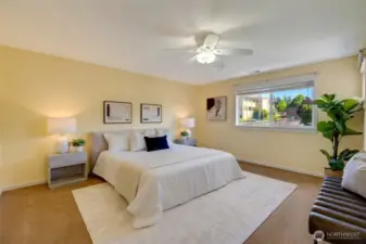 Primary bedroom with neutral tones, ceiling fan, and plush carpet—move-in ready and filled with natural light.