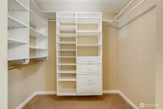 Primary walk-in closet with custom built-in shelving and ample storage—maximize organization in your Kent condo bedroom.