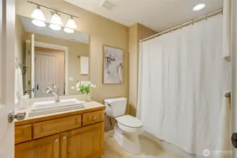 Full guest bathroom with oversized vanity, modern lighting, and a shower/tub combo—perfect for daily routines or guest comfort.