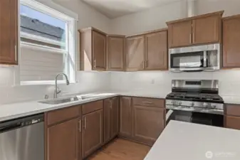 The kitchen has a gas bbq, microhood and dishwasher.
