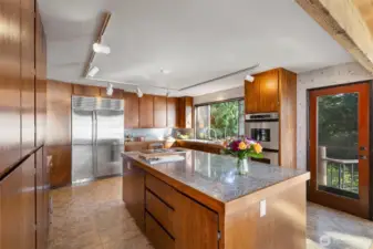 Cooking and entertaining in this large kitchen iw a delight.  Plenty of room for helping hands, loads of storage and a large freezer and refrigerator too.  the double ovens are a plus when cooking or baking for larger gatherings.  There are two doors to the entertainment deck, one from the kitchen area and large sliding glass doors off the family room area.