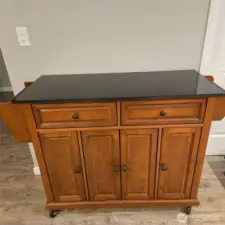 Sellers are willing to convey this furniture piece for use as kitchen island.