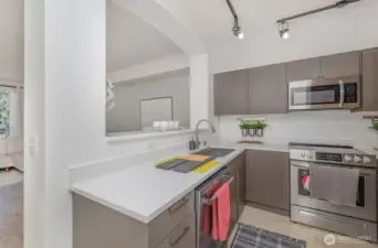 Kitchen features neutral-toned cabinetry, premium stainless steel appliances, and plenty of storage.