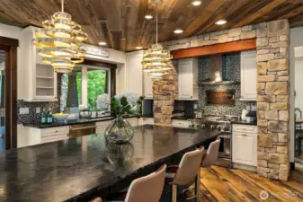 Dramatic stone surround in the kitchen.  Leathered granite countertops, walk in pantry, appliance garage, pot filler.  Reclaimed barnwood ceiling.