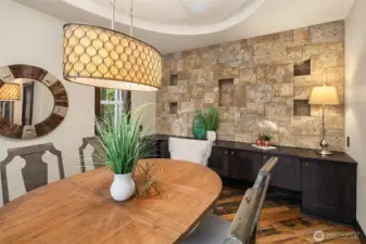 Formal dining room off of kitchen is perfect for all your holiday events.  It features a cultured stone wall with spa like feel and cantilevered ceiling.
