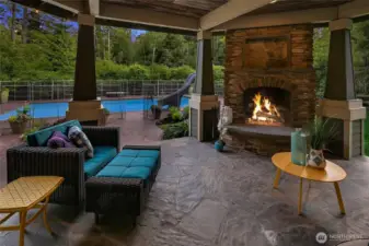 Covered outdoor patio has a wood burning fireplace, cultured stone surround, ceiling heat & is plumbed for a natural gas smoker or BBQ.