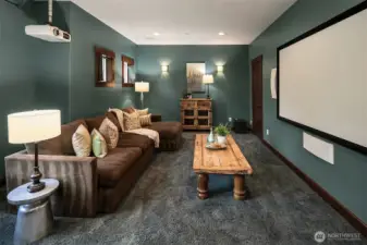 Sprawling media room features Projection TV and built in Sonos speakers, boosters and sound bars