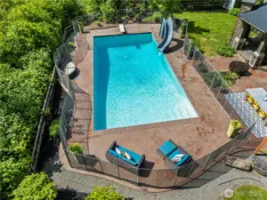 Stamped concrete pool decking, fully fenced with electric retractable cover.