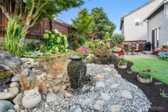 Tranquil garden fountain nestled among blooming florals