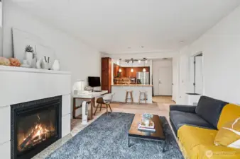 The bright living area with cozy fireplace welcomes you