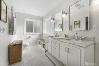 Updated primary bath boasts tile heated floors, curdles shower and dual sinks